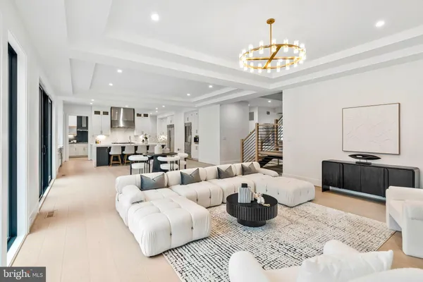 a living room with furniture a window and wooden floor