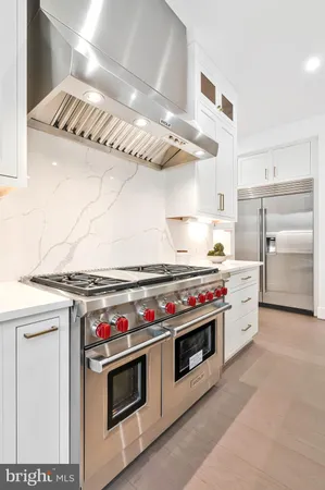 a large bedroom with a bed and a chandelier