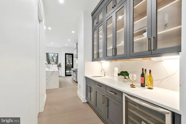 a spacious bathroom with a double vanity sink a mirror and a bathtub