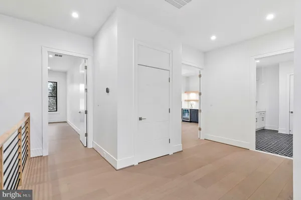 an empty room with windows and fireplace