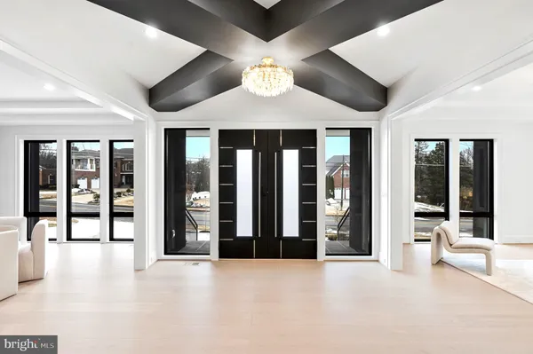 a spacious bedroom with a large bed and a large window