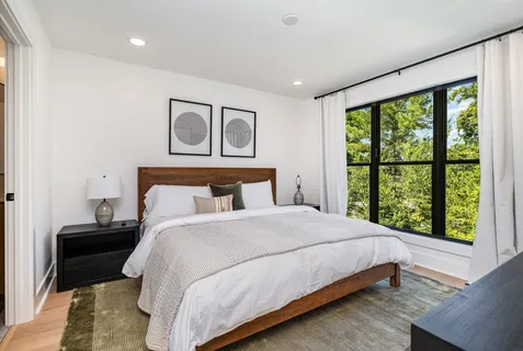 a bedroom with a bed and a window