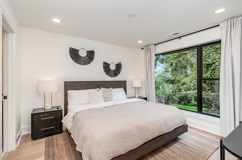 a bedroom with a large bed and a large window