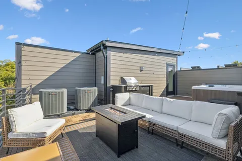 a view of a terrace with couches and sky view