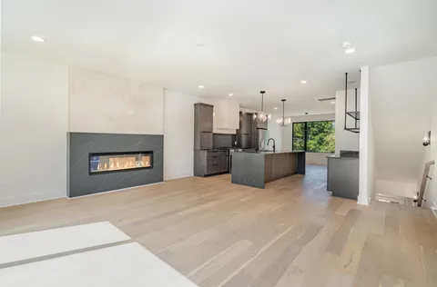 a view of a kitchen with a sink and a fireplace