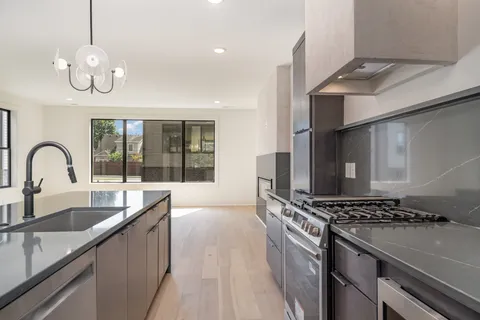 a kitchen with a sink and a stove top oven