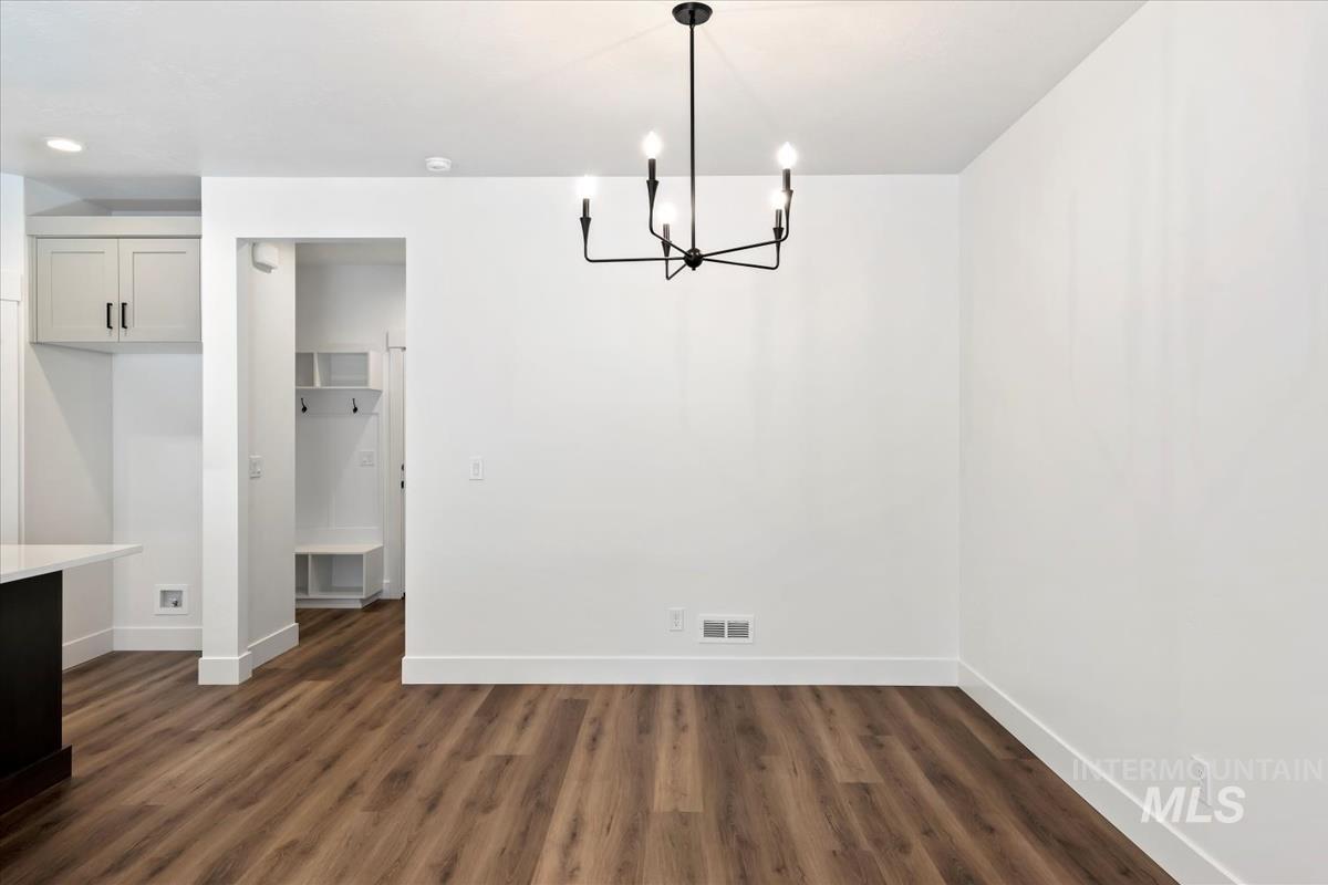752 South Calhoun Lane Star, ID 83669 - Photo 15 of 45 Dining area featuring wood-finish flooring and a contemporary black chandelier