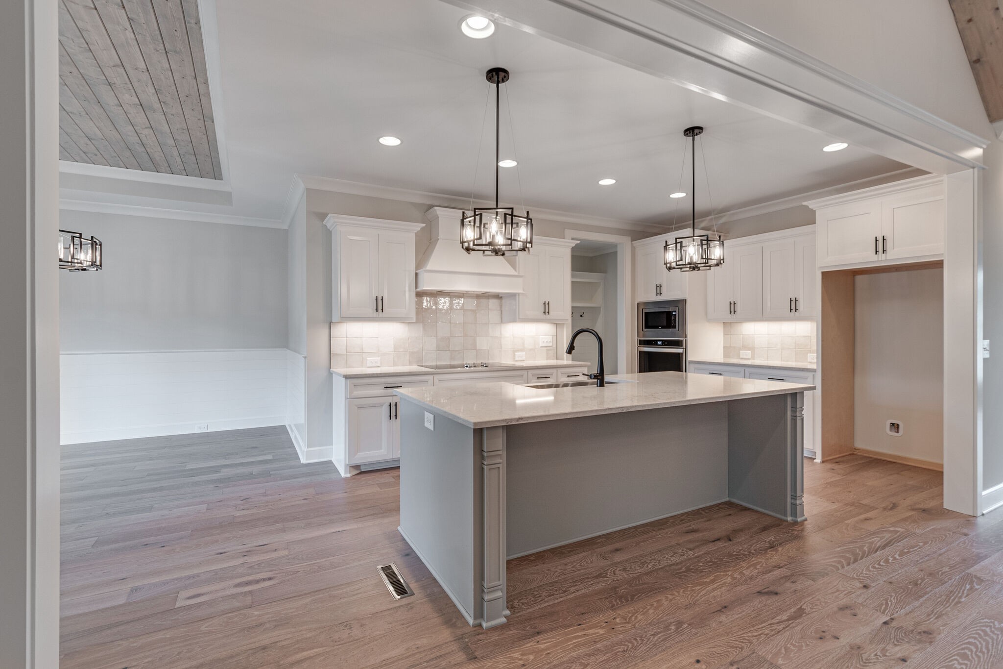 1497 Phillips Road Lebanon, TN 37087 - Photo 13 of 43 a large kitchen with granite countertop a large island in the center and stainless steel appliances