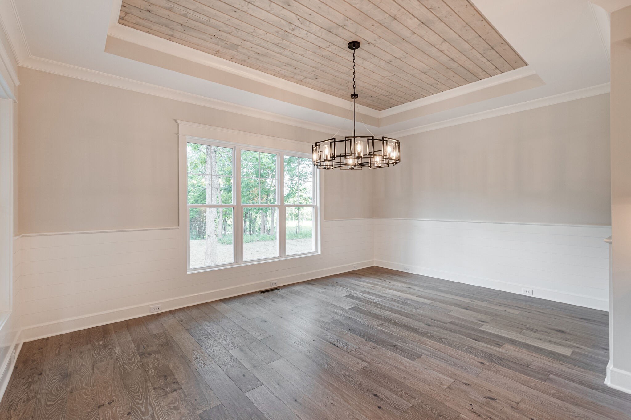 1497 Phillips Road Lebanon, TN 37087 - Photo 18 of 43 a view of an empty room with wooden floor chandeliers and a window