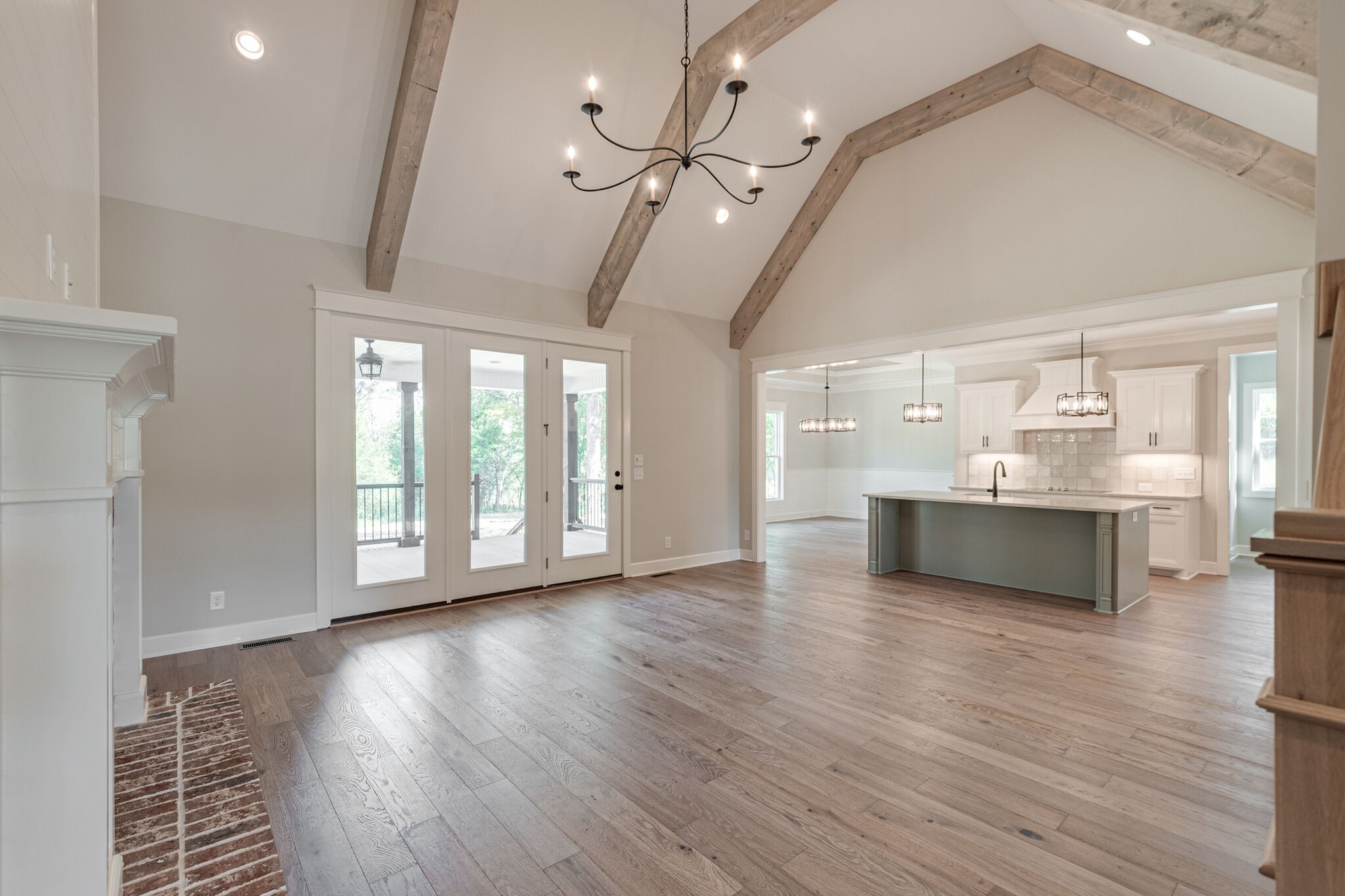 1497 Phillips Road Lebanon, TN 37087 - Photo 6 of 43 a view of an empty room with a kitchen and wooden floor
