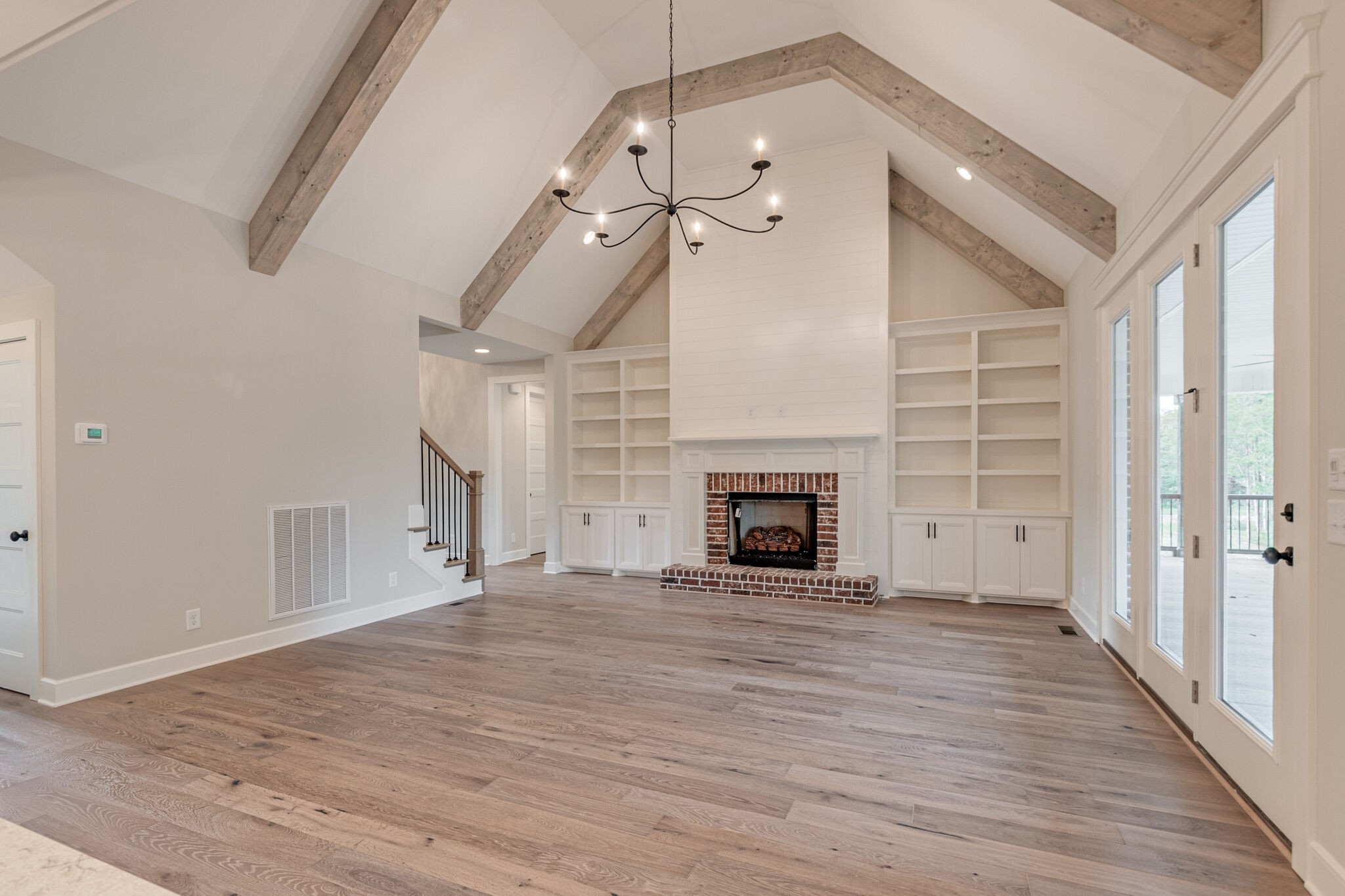 1497 Phillips Road Lebanon, TN 37087 - Photo 8 of 43 a view of empty room with wooden floor fireplace and a window