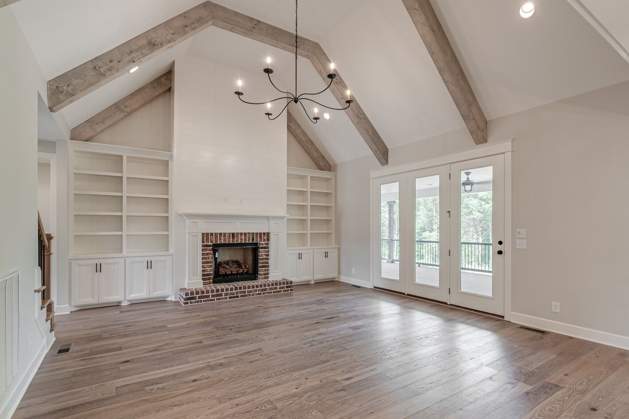 1497 Phillips Road Lebanon, TN 37087 - Photo 10 of 43 wooden floor fireplace and windows in an empty room