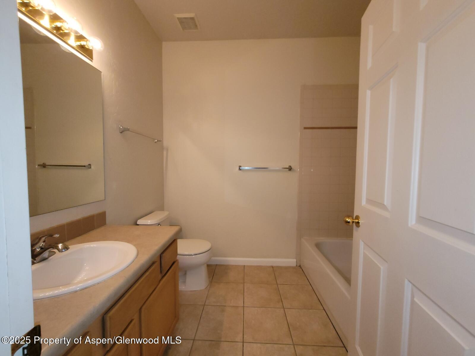 2701 Midland Avenue, Unit 511 Glenwood Springs, CO 81601 - Photo 12 of 21 a bathroom with a granite countertop sink toilet and shower