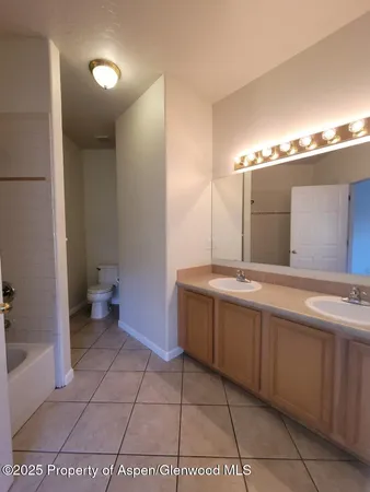 a bathroom with a tub a sink and mirror