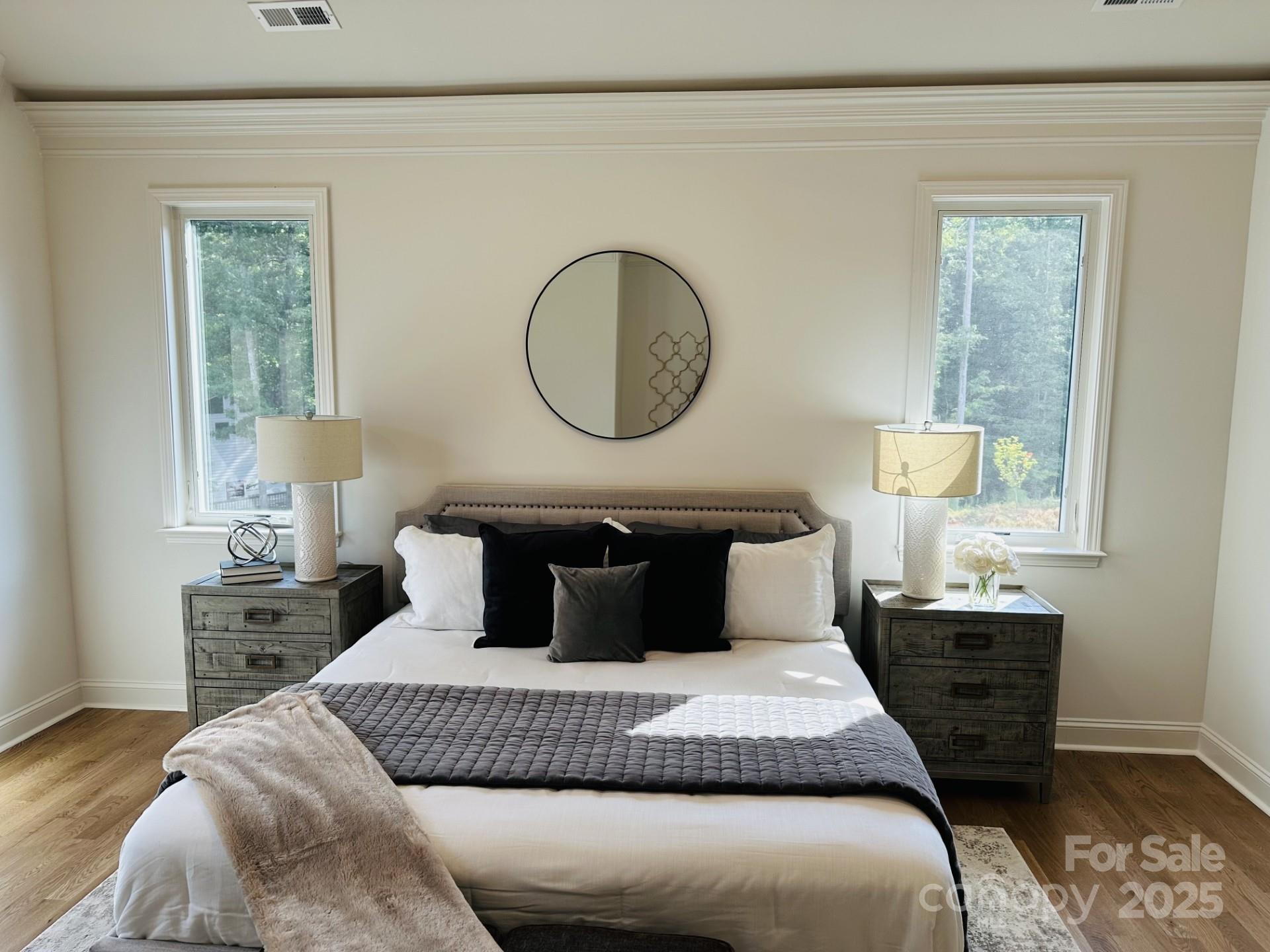 92 Silver Trce Lane Denver, NC 28037 - Photo 6 of 10 a bedroom with a bed a mirror and a lamp on dresser