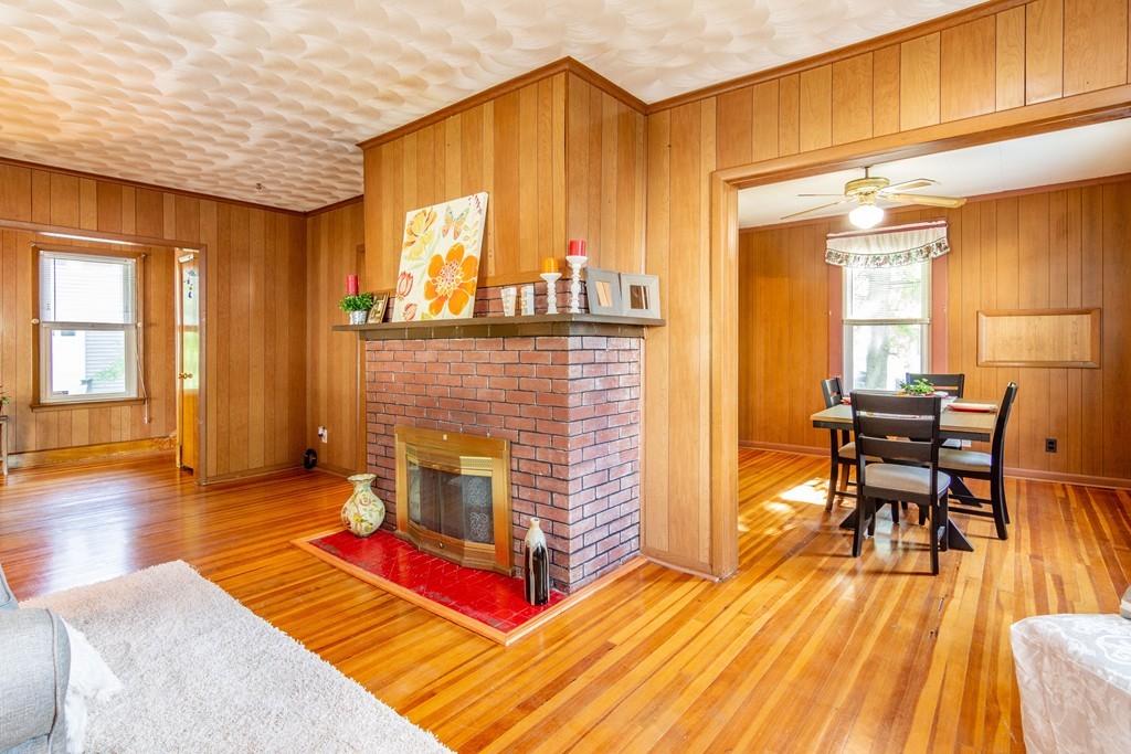 55 Crown Street Springfield, MA 01108 - Photo 11 of 30 a living room with a fireplace furniture and a wooden floor