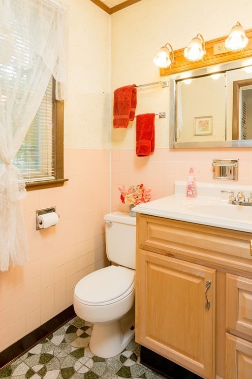 55 Crown Street Springfield, MA 01108 - Photo 4 of 30 a bathroom with a toilet sink vanity and mirror