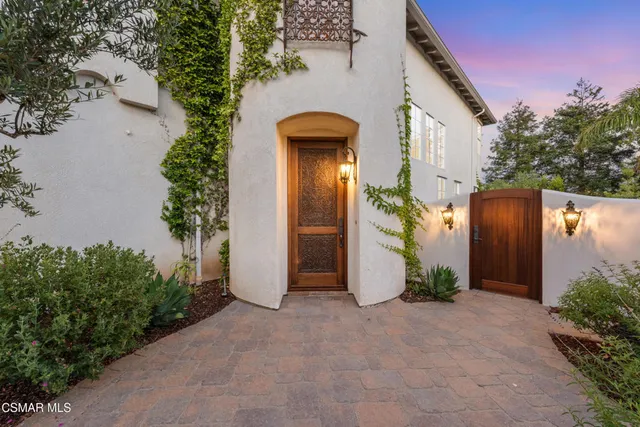 an entrance to house with yard and green space
