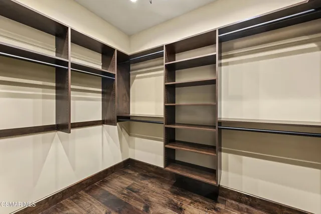 a bedroom with bed and wooden floor