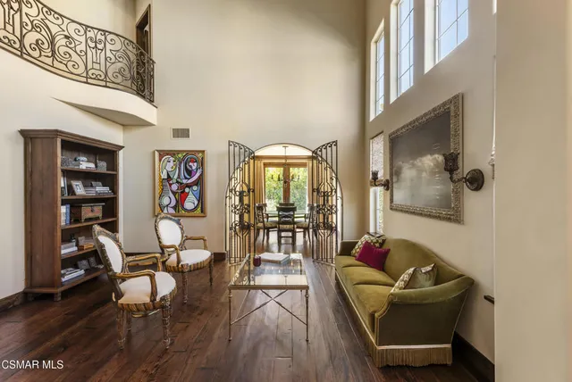a living room with furniture and a floor to ceiling window
