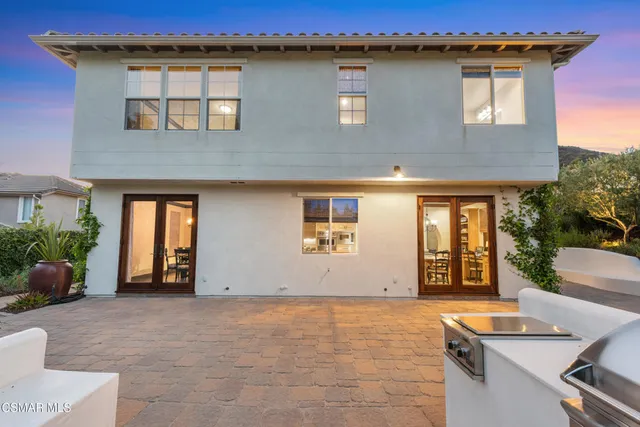 a view of a white house with a yard