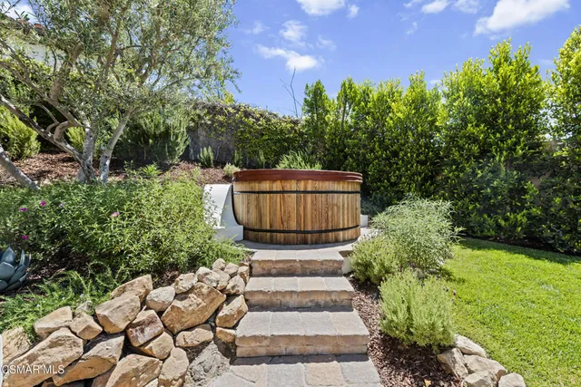 a view of backyard with outdoor seating and green space