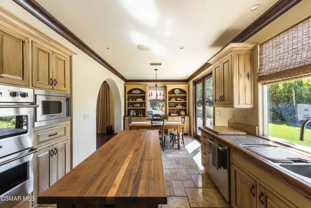 a kitchen with stainless steel appliances kitchen island granite countertop a sink and counter space