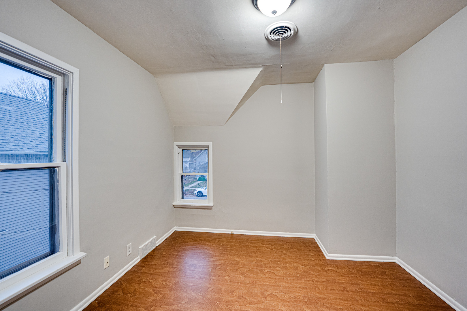 735 Sexton Street, Unit 2 Aurora, IL 60505 - Photo 11 of 18 a view of an empty room with wooden floor and a window