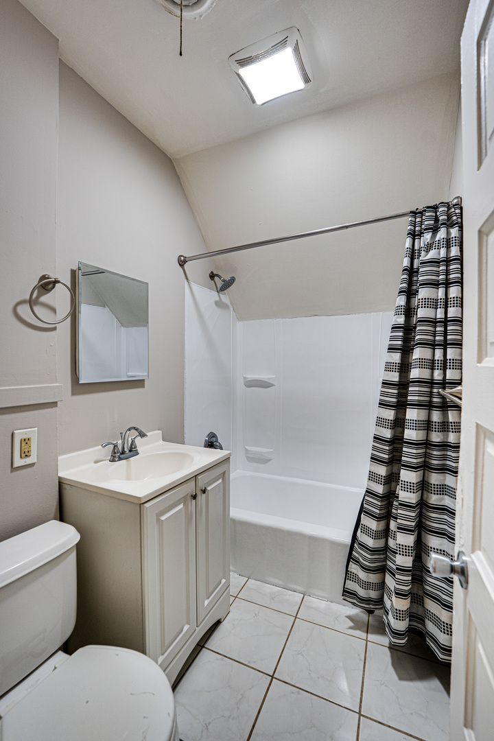 735 Sexton Street, Unit 2 Aurora, IL 60505 - Photo 7 of 18 a bathroom with a sink a toilet and mirror