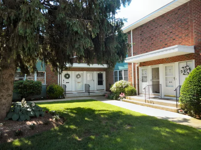 a house view with swimming pool in front of it