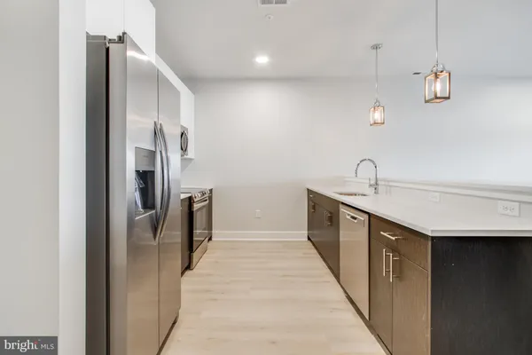 a kitchen with stainless steel appliances a refrigerator and a sink