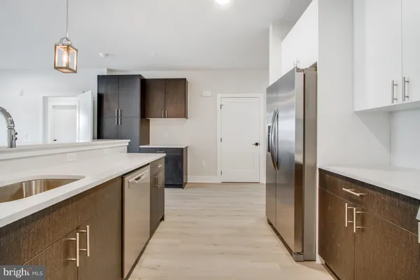 a kitchen with stainless steel appliances granite countertop a refrigerator and a sink