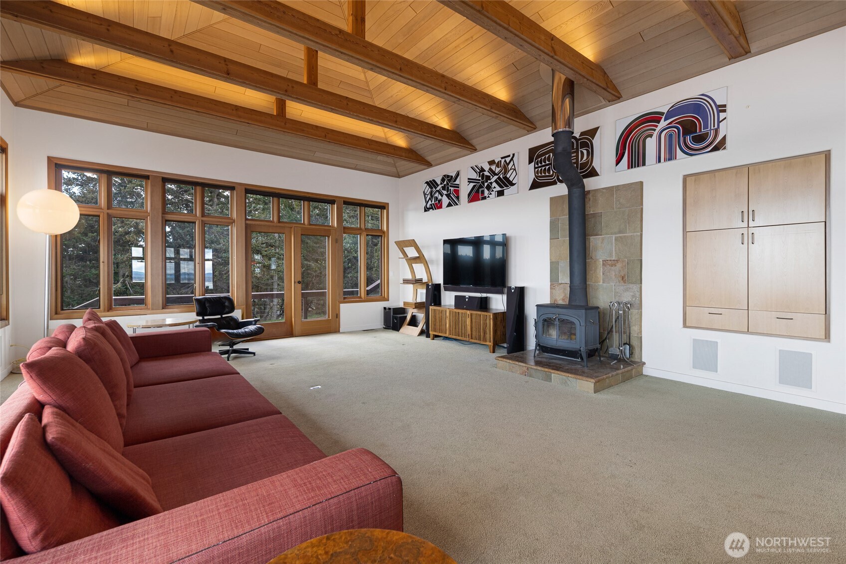 571 Golf Course Road Friday Harbor, WA 98250 - Photo 13 of 38 a living room with furniture a flat screen tv and large window