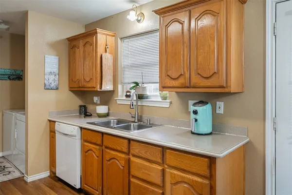 a kitchen with sink and mirror