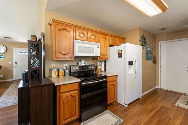 a kitchen with stainless steel appliances a refrigerator sink and cabinets