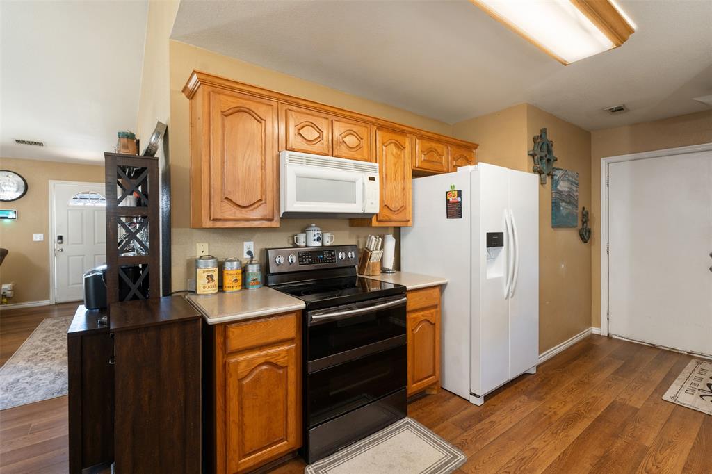 924 Guam Street Tool, TX 75143 - Photo 13 of 29 a kitchen with stainless steel appliances a refrigerator sink and cabinets