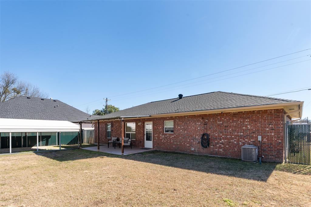 924 Guam Street Tool, TX 75143 - Photo 22 of 29 a front view of a house with a yard