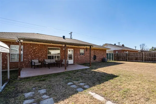 a view of a house with backyard porch and sitting area