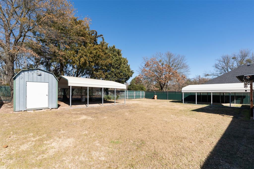 924 Guam Street Tool, TX 75143 - Photo 27 of 29 a front view of a house with a yard and trees