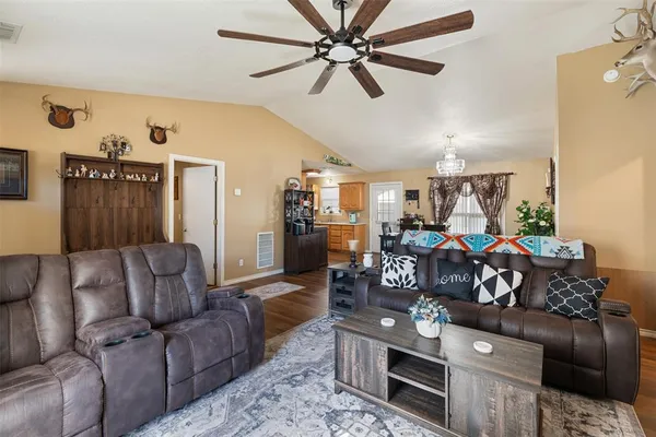a living room with furniture and a wooden floor