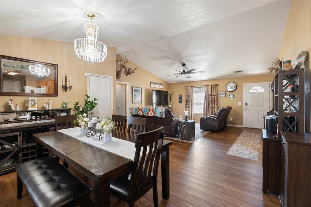 924 Guam Street Tool, TX 75143 - Photo 10 of 29 a view of a dining room with furniture a chandelier and wooden floor