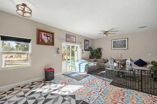 a living room with furniture a rug and a table
