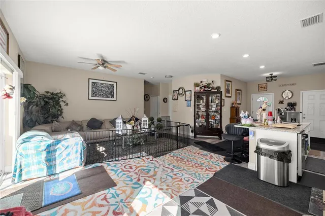 a view of a kitchen with a sink and wooden floor