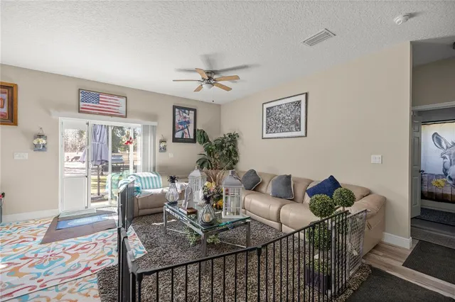 a view of a dining room with furniture and kitchen view