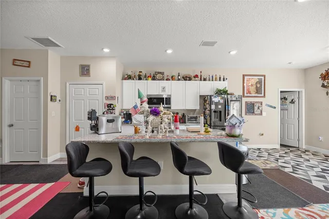 a bedroom with a bed and a lamp on dresser