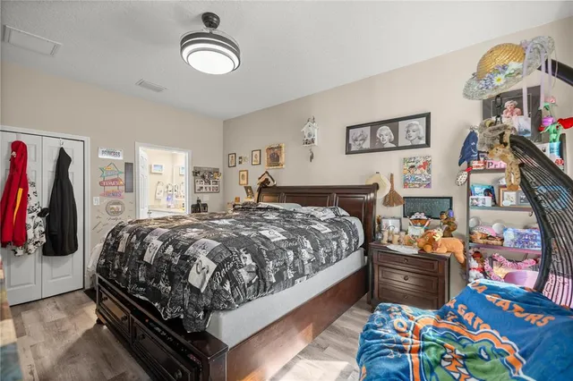 a bedroom with a bed a flat screen tv and a a large mirror