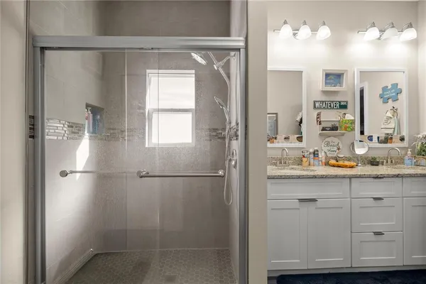a bathroom with a granite countertop sink a mirror and vanity
