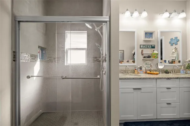 a bathroom with a granite countertop sink a mirror and vanity