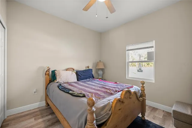 a bedroom with bed and a flat screen tv