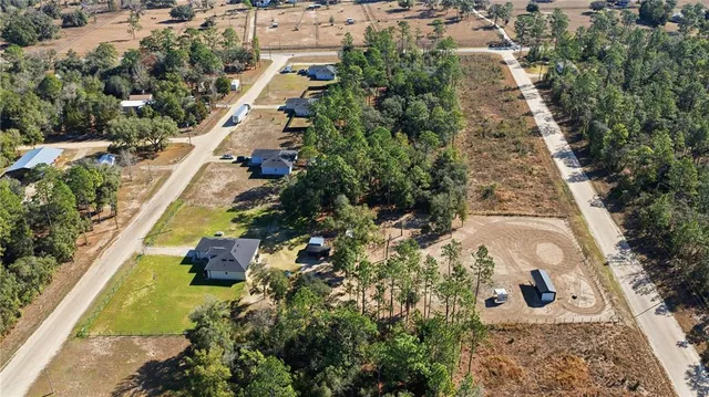 an aerial view of a house with a yard and lake view